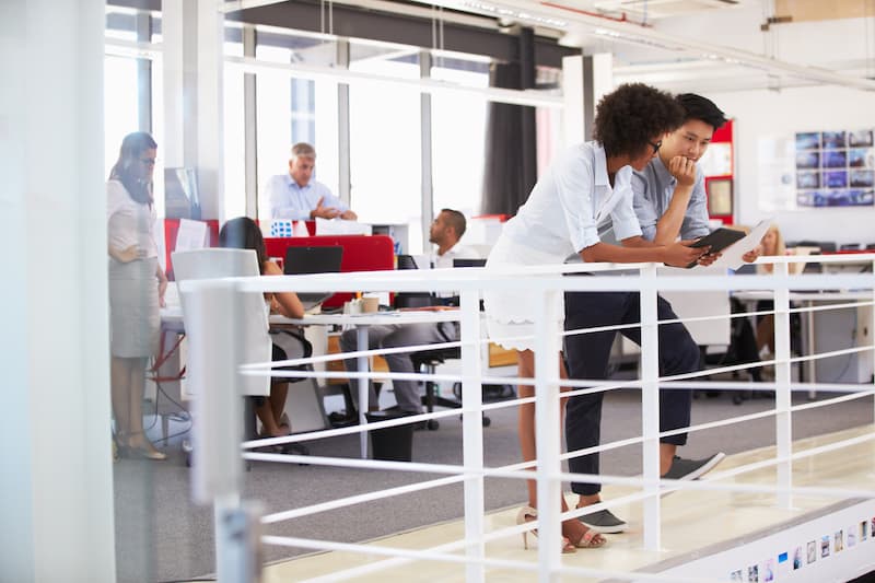 Staff working in a busy office mezzanine